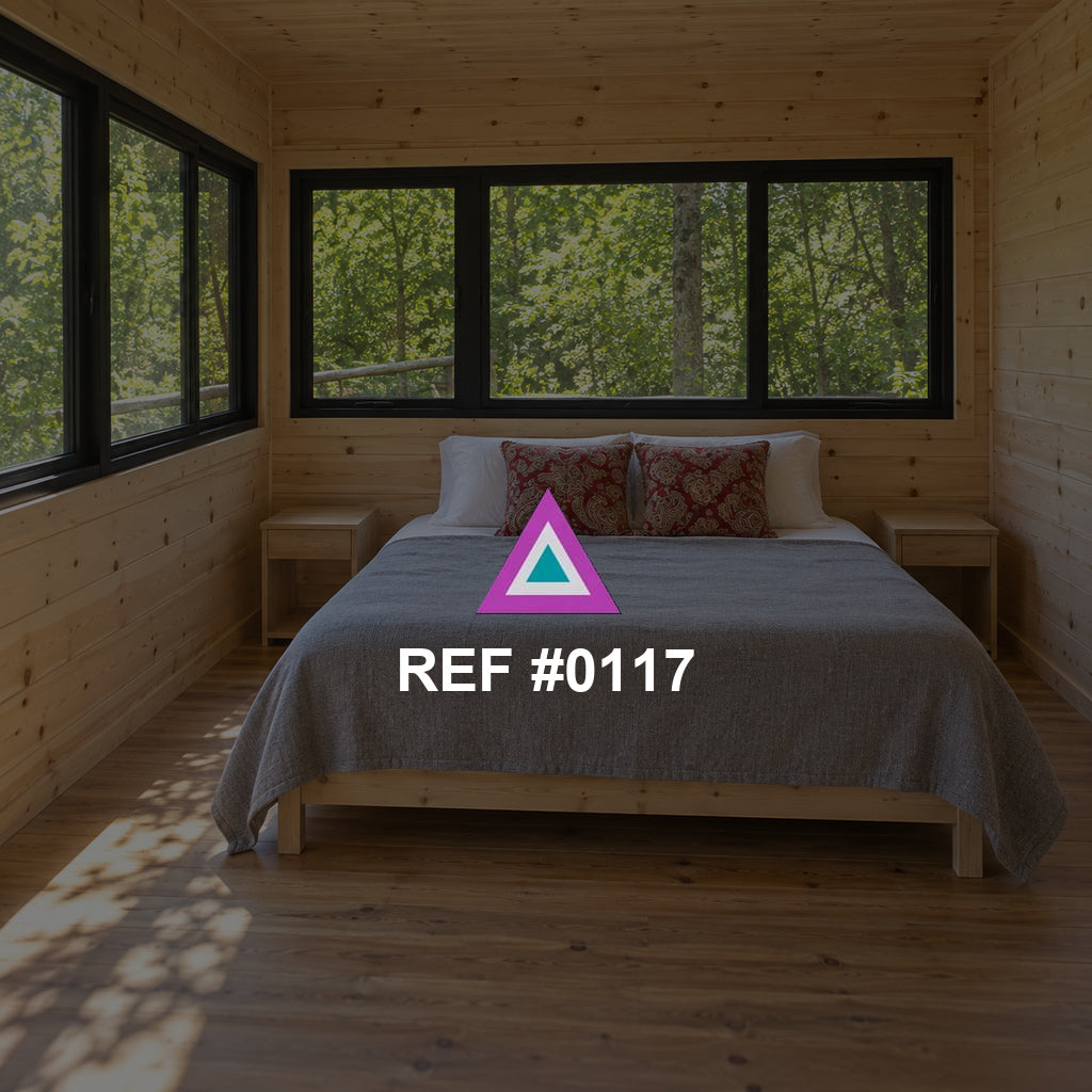 Refugio del Bosque. Una cama en una habitación revestida de madera, con ventanas abiertas hacia el verde.